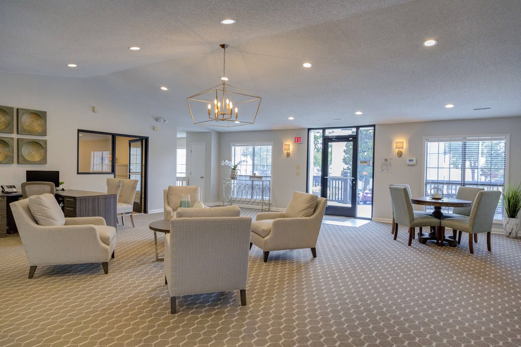 a large living room with couches chairs and a table