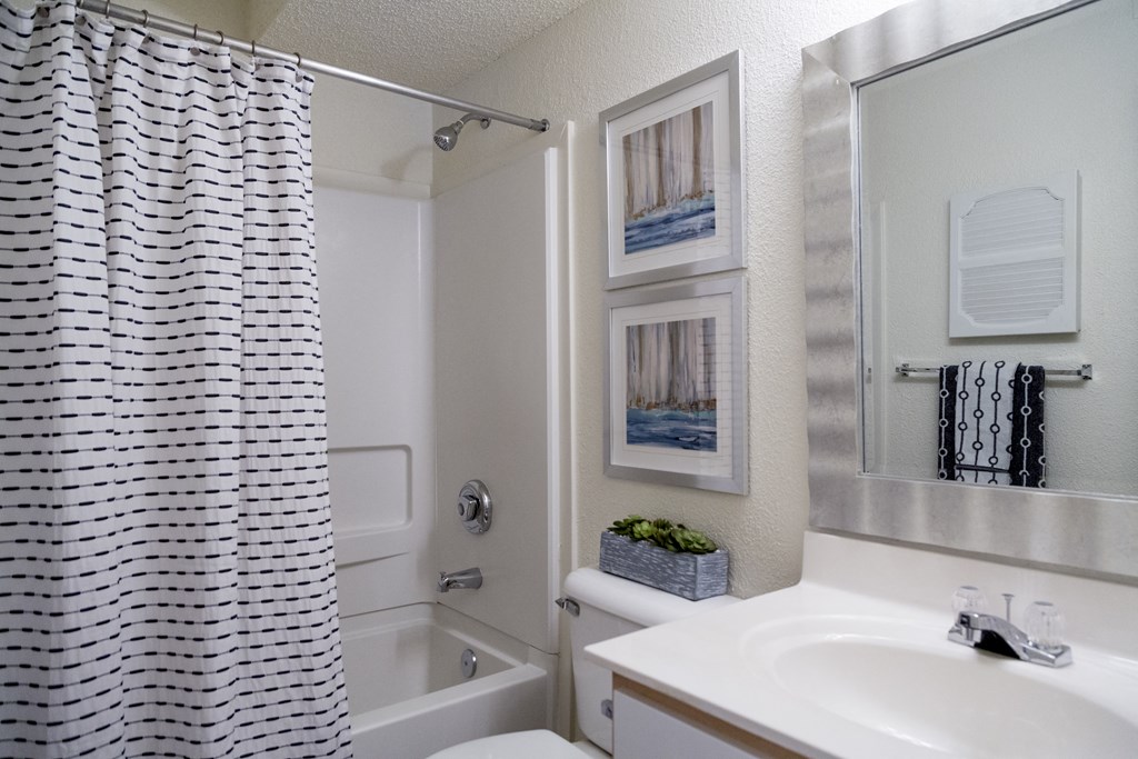 a bathroom with a shower and a sink and a toilet