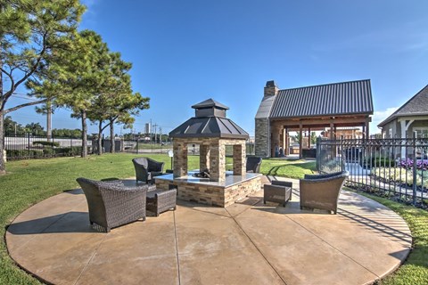 A backyard with a fire pit and seating area.
