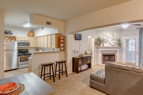A modern kitchen with a dining table and a couch.