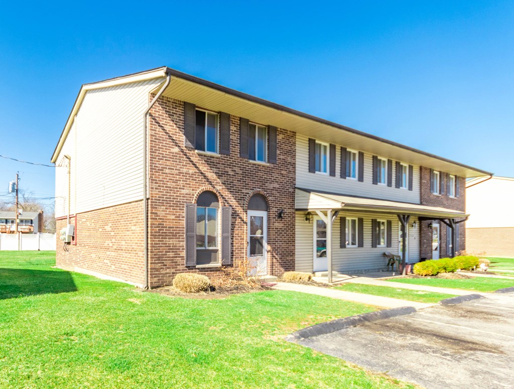A house with a brick facade and a covered porch.