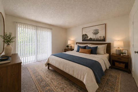 A bedroom with a bed, nightstands, and a painting on the wall.