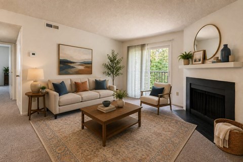 A living room with a fireplace and a painting on the wall.