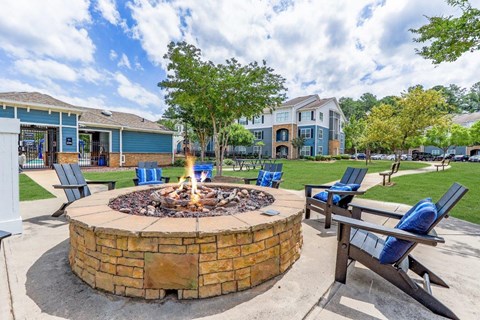 our fire pit is surrounded by chairs and a table and chairs