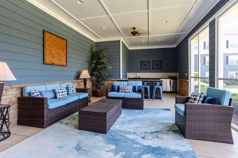 a living room with couches and chairs and a table