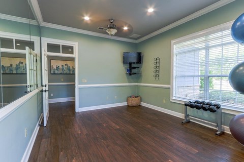 a living room with a large window and a hard wood floor