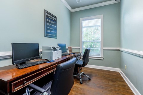 a home office with a desk with a computer and a printer