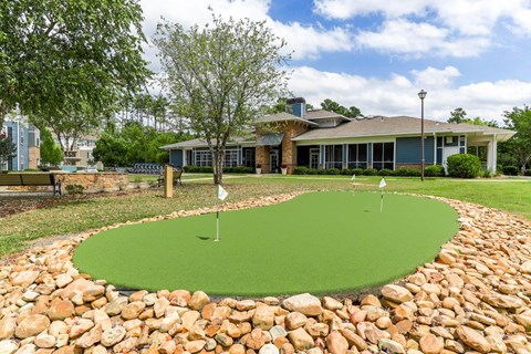 a putting green in front of a house