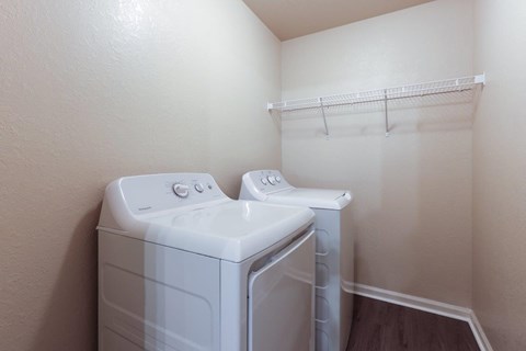 a white washer and dryer in a room with a closet