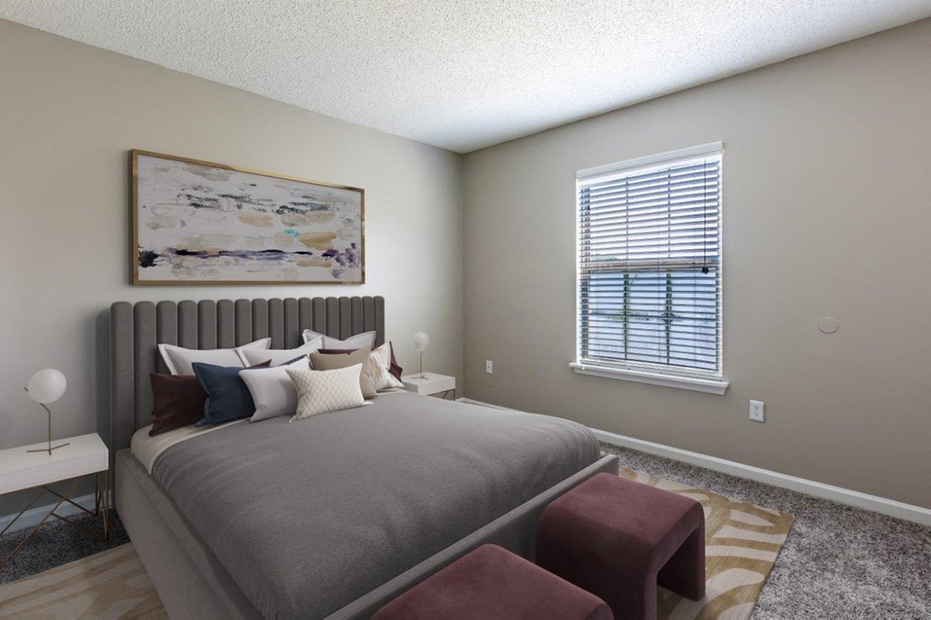 Staged bedroom with wall to wall carpeting