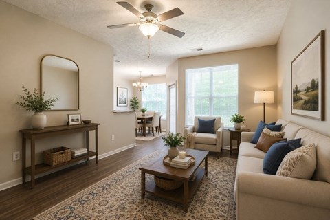 A living room with a white ceiling fan and a large mirror on the wall.