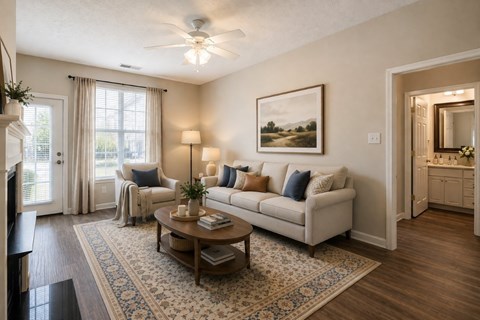 A living room with a white couch, a coffee table, and a painting on the wall.