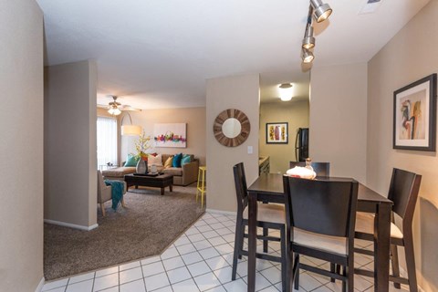A dining room with a table and chairs.
