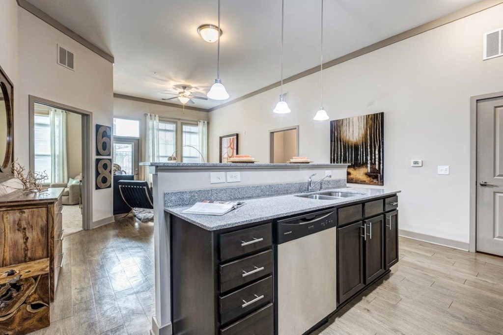 A modern kitchen with a large island and stainless steel appliances.