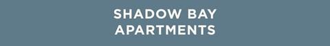 The image displays the text "Shadow Bay Apartments" in a large, bold font centered on a plain background.