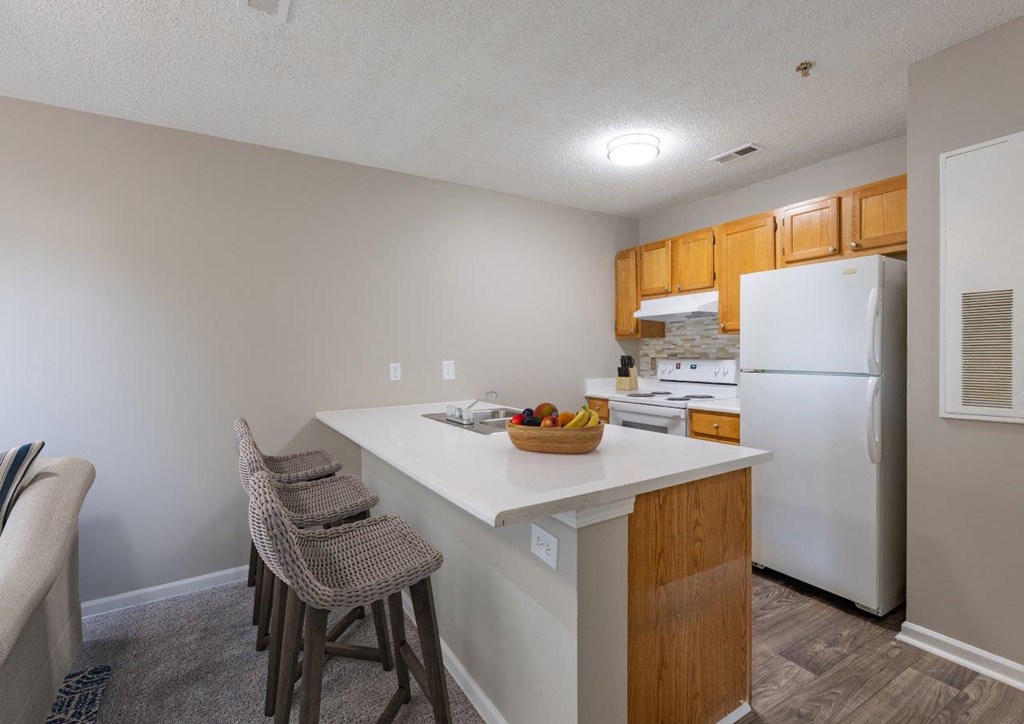 a kitchen with a counter top and a refrigerator