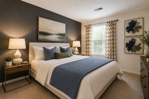 A bedroom with a large bed and a painting on the wall.