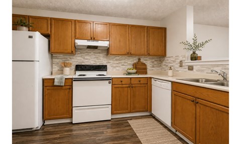 A kitchen with wooden cabinets and white appliances.