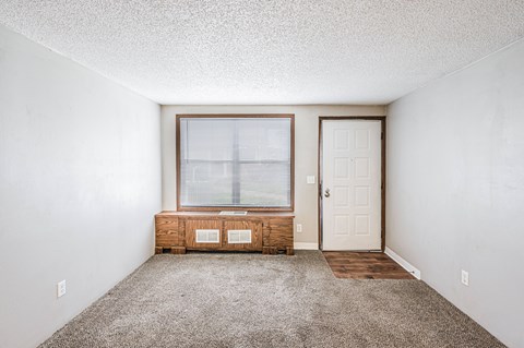 A room with a window and a door.