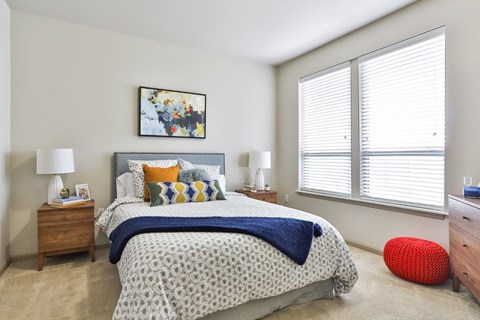 bedroom with carpet and large windows