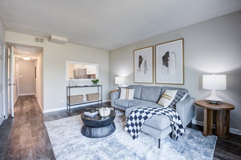A living room with a grey couch and a coffee table.