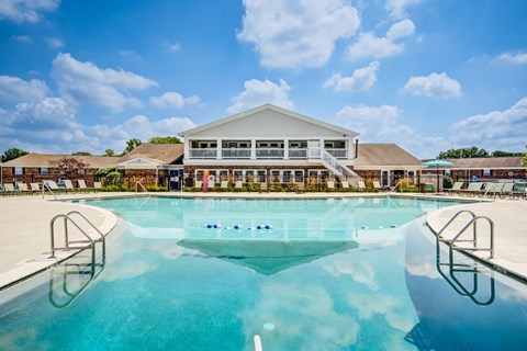 A large swimming pool in front of a building.