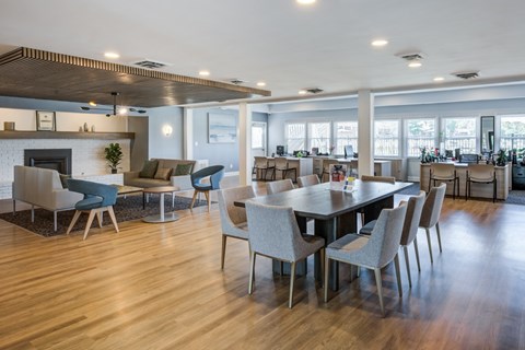 A modern dining room with a large table and chairs.