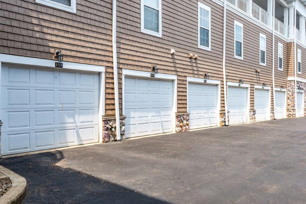 a row of three garage doors on the side of a building