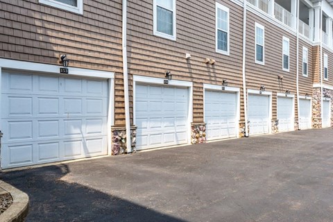 a row of three garage doors on the side of a building
