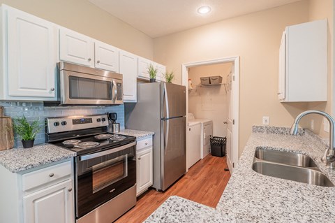 a kitchen with stainless steel appliances and granite counter tops
