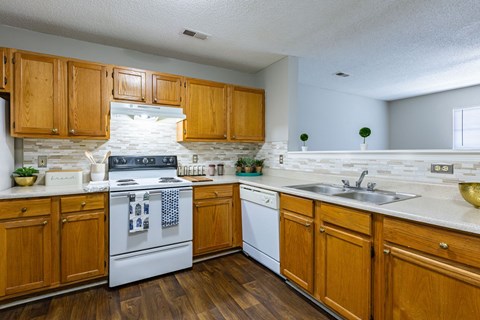 a kitchen with white appliances and wooden cabinets