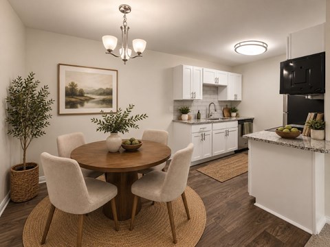 A dining room with a round table and chairs.