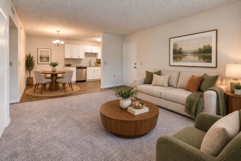 A living room with a grey carpet and a green couch.
