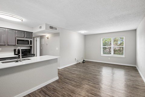 A kitchen with a countertop and a microwave.