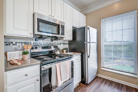 a kitchen with a stove microwave and refrigerator