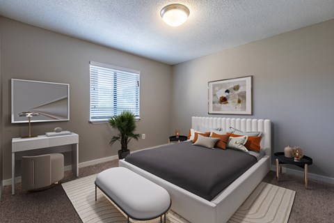 a bedroom with a bed and a desk and a mirror