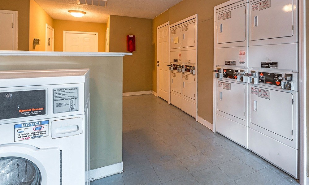 a laundry room with a washer and dryer and some white appliances