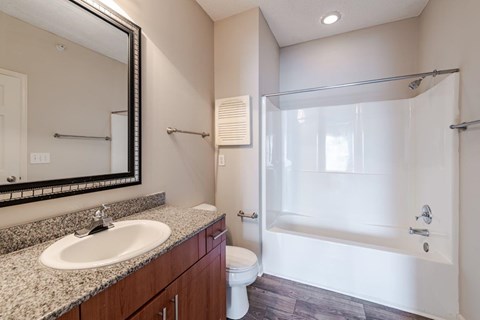 A bathroom with a sink, toilet, and shower.