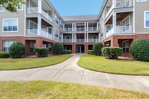 Apartment complex with a central courtyard and a mix of brick and siding exteriors.