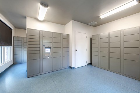 A room with a white door and a row of lockers.