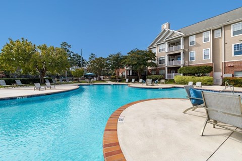 A swimming pool with a chair on the side.