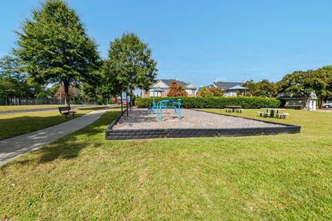 A playground with a slide and a swing set.