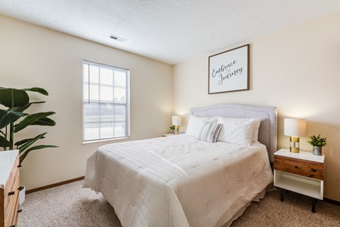 a bedroom with a bed and a window