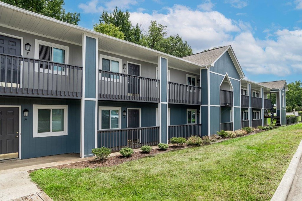 A row of townhouses with balconies and doors.