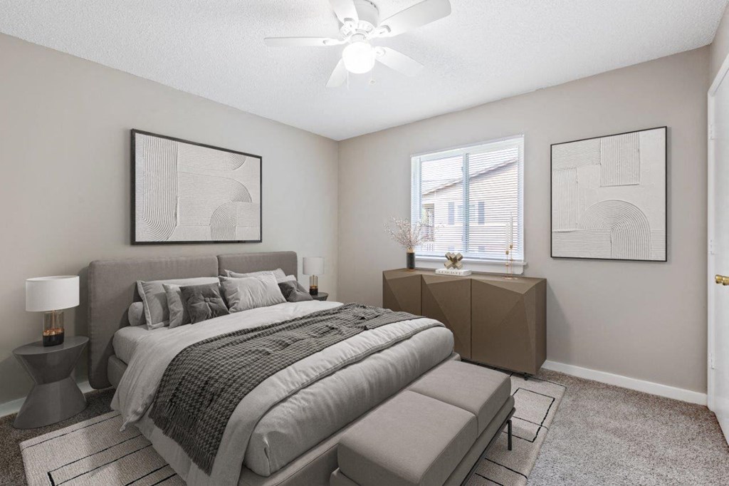 staged bedroom with wall to wall carpeting