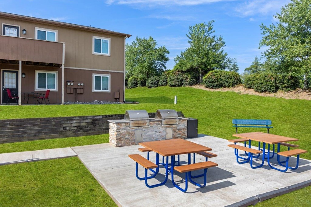 grilling area with picnic tables