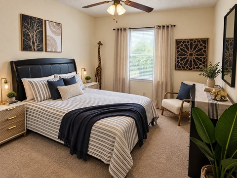 A bedroom with a large bed and a ceiling fan.