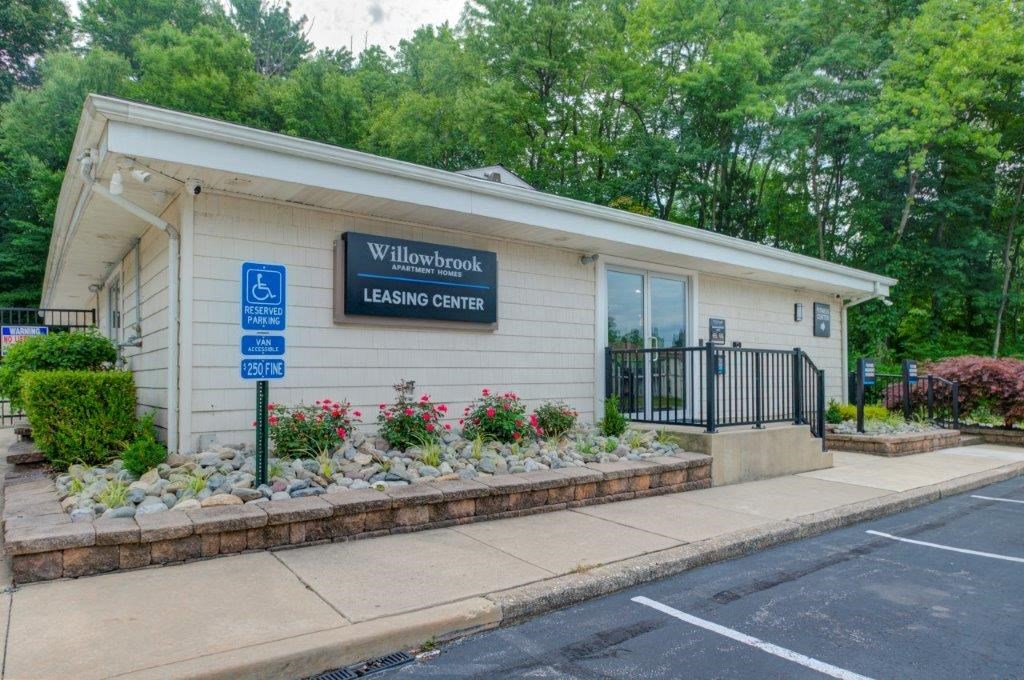 a white building with a sign on the side of a street
