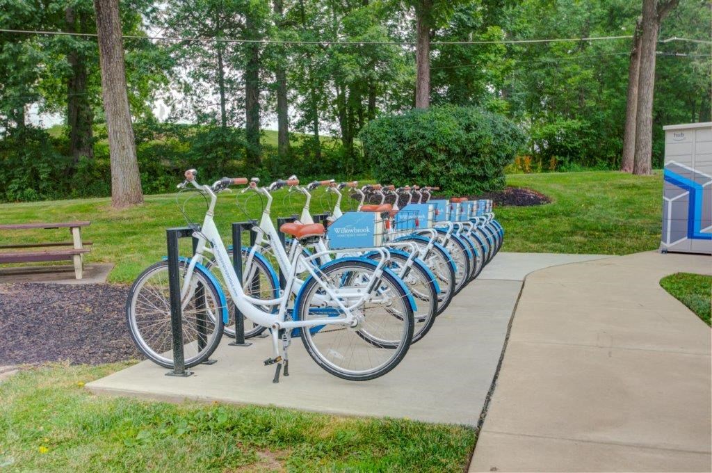 a row of bikes parked next to each other on a sidewalk