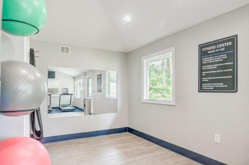 a workout room with a gym ball and a sign on the wall
